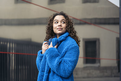 Portrait of beautiful young woman standing outdoors