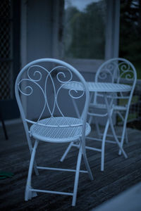 Close-up of chairs on table