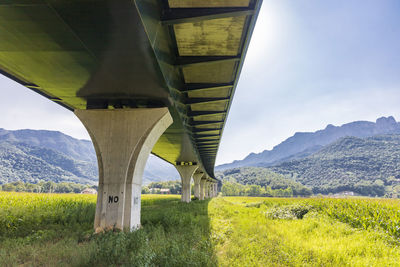 Modern bridge in the countryside over deserted roads and beautiful mou