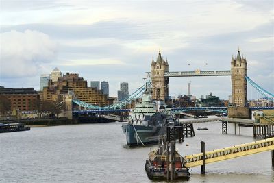 Boats in river with city in background