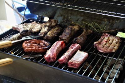 High angle view of meat on barbecue grill