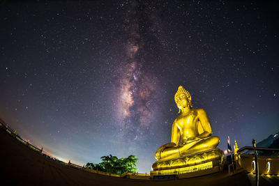 Low angle view of statue against sky at night