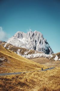 Scenic view of snowcapped mountains against clear blue sky