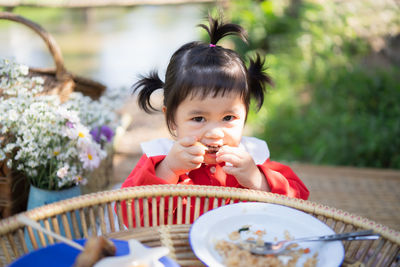 Portrait of cute girl sitting on table