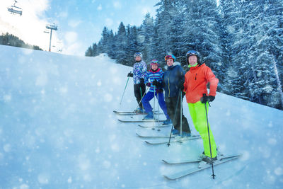 People skiing on snow covered landscape