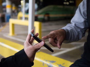 Cropped image of woman holding cigarette