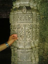 Woman holding cross in a temple