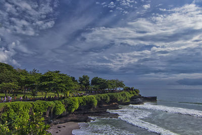 Great landscape view of cliff in tanah lot with heavy wave hitting the beach