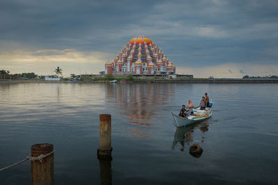 People in boat against sky