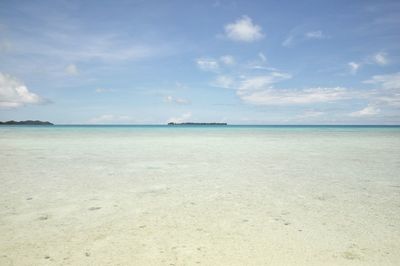 View of beach against cloudy sky