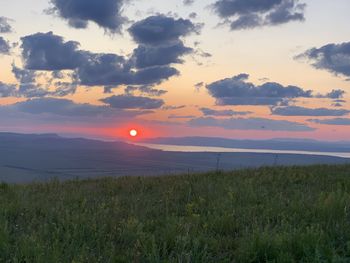 Scenic view of field against sky during sunset