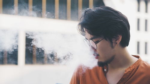 Young man smoking outdoors