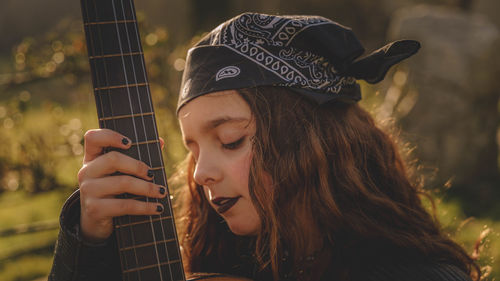 Teenage woman with guitar