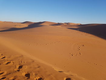 Scenic view of desert against clear sky