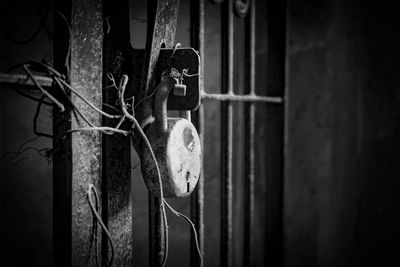 Close-up of old metal hanging against wall