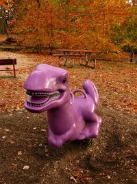 Close-up of child on slide in park during autumn