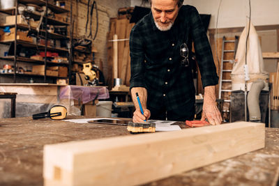 Carpenter working in factory