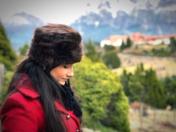 Portrait of young woman looking at mountains