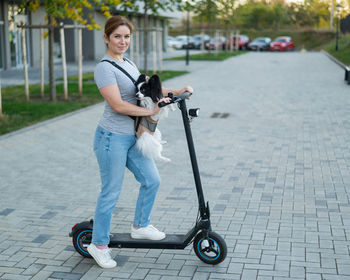 Full length of woman holding camera