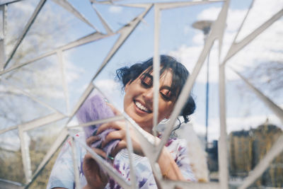 Portrait of smiling young woman using mobile phone