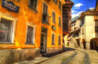 Street amidst buildings in city against sky