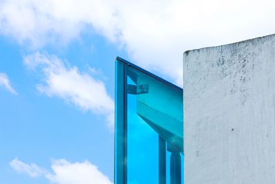 Low angle view of road sign against blue sky