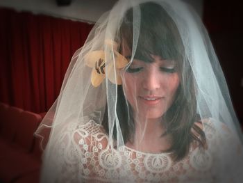 Close-up of bride wearing wedding dress