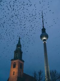 Low angle view of communications tower against sky