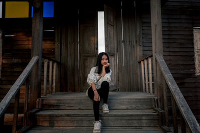 Portrait of woman sitting on staircase