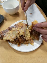 Close-up of hand holding ice cream served in plate