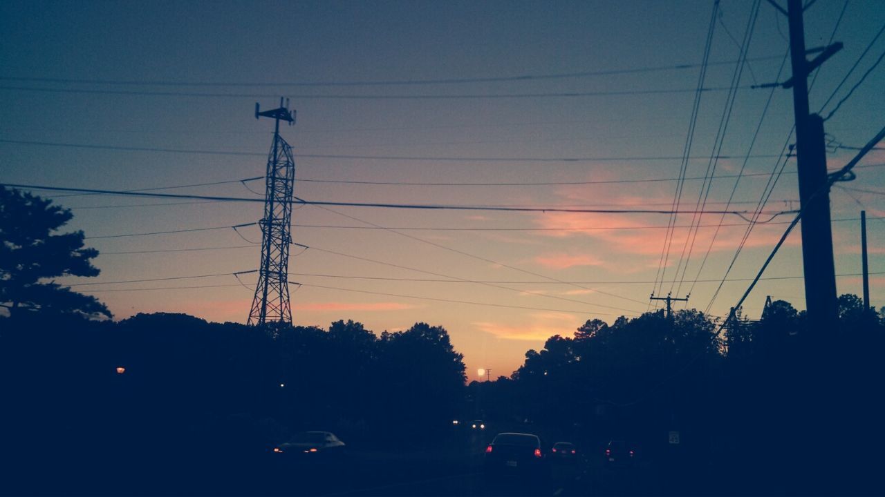 power line, electricity pylon, power supply, silhouette, electricity, sunset, cable, sky, connection, power cable, tree, transportation, fuel and power generation, low angle view, technology, dusk, street light, car, cloud - sky, no people