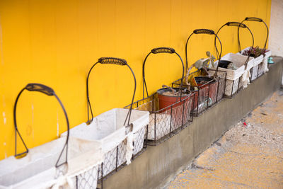 High angle view of baskets by yellow wall