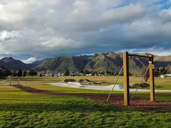 Scenic view of field against cloudy sky