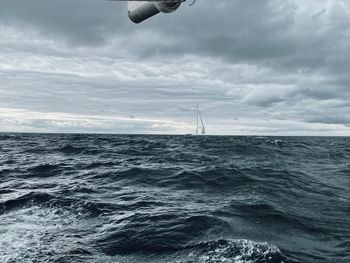 Sailboat in sea against sky