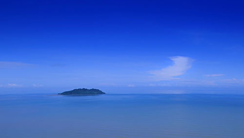 Scenic view of sea against blue sky