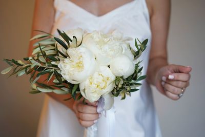 Midsection of bride woman holding wedding flower bouquet