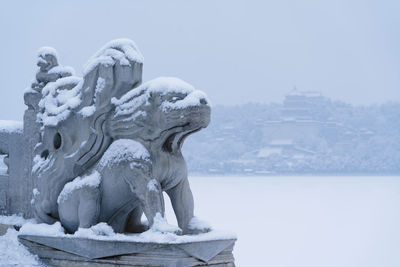 Statue against sky during winter