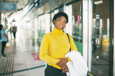 Portrait of smiling man standing in bus