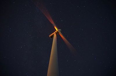 Low angle view of wind turbine against sky at night