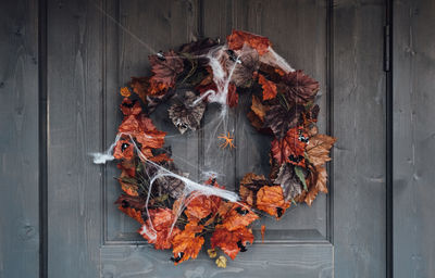 High angle view of autumn leaves on wooden door