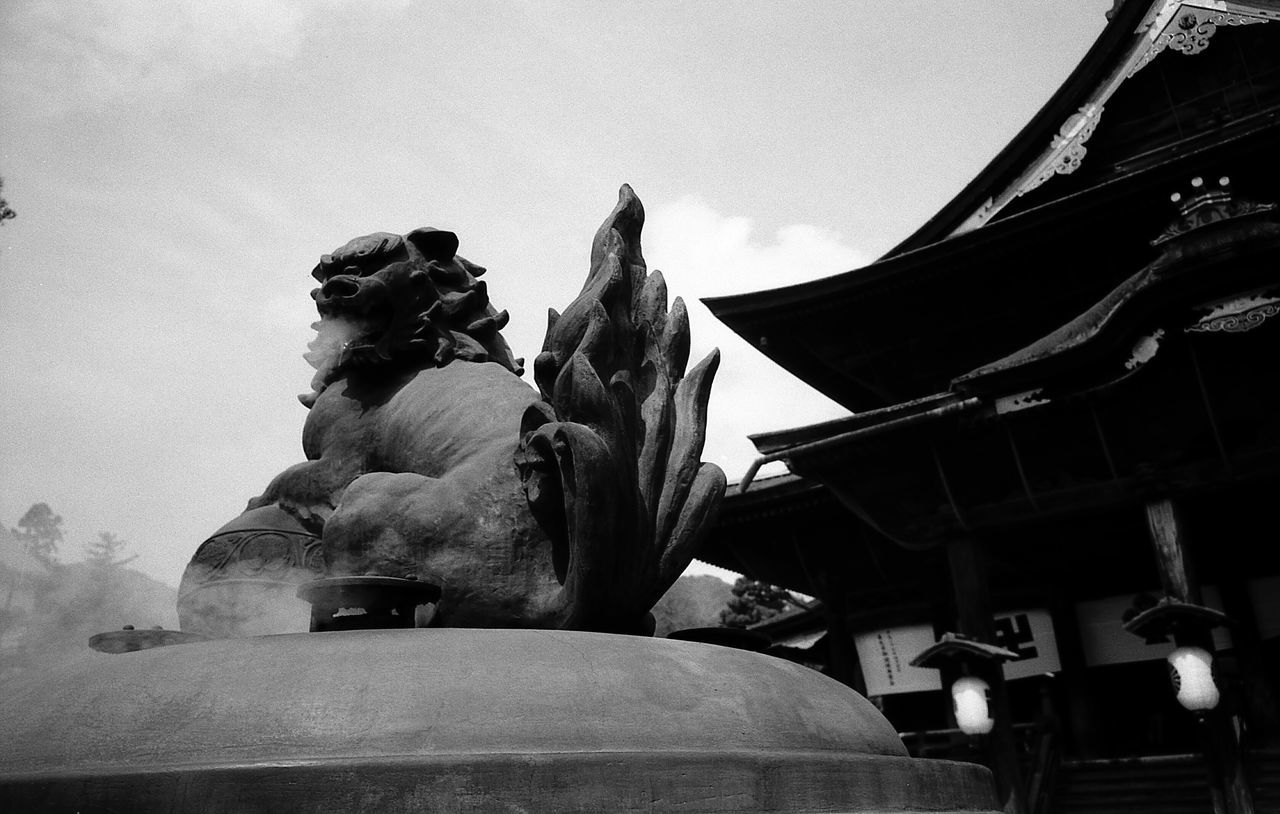 statue, sculpture, human representation, low angle view, art and craft, male likeness, no people, day, sky, outdoors, built structure