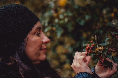 Portrait of woman holding red flower