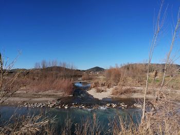 Scenic view of land against clear blue sky