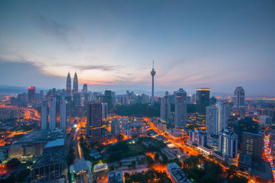 Aerial view of city lit up at night