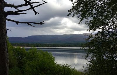 Scenic view of lake against cloudy sky