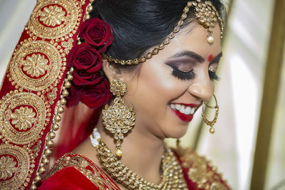 Close-up of smiling bride with eyes closed