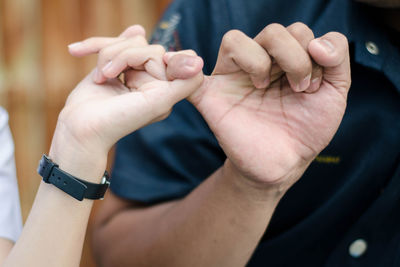Close-up of man holding hands