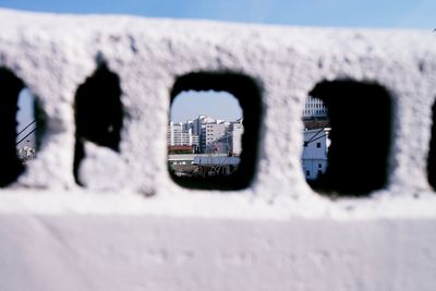 Close-up of snow on landscape against sky