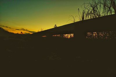 Low angle view of silhouette bridge at sunset