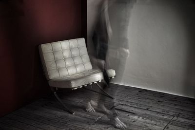 Low section of person standing on hardwood floor at home
